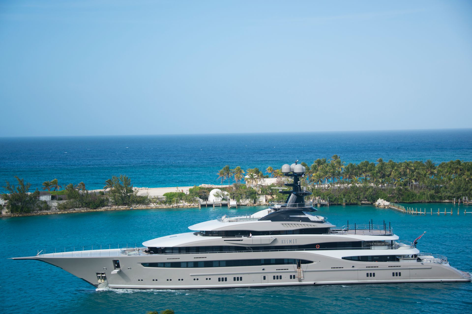 Luxury superyacht cruising on calm deep-blue water at sea